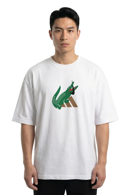 A man wearing a white short-sleeve t-shirt with a green and brown crocodile graphic on the chest, set against a plain white background.