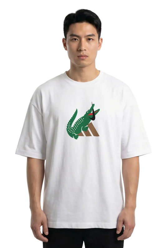 A man wearing a white short-sleeve t-shirt with a green and brown crocodile graphic on the chest, set against a plain white background.