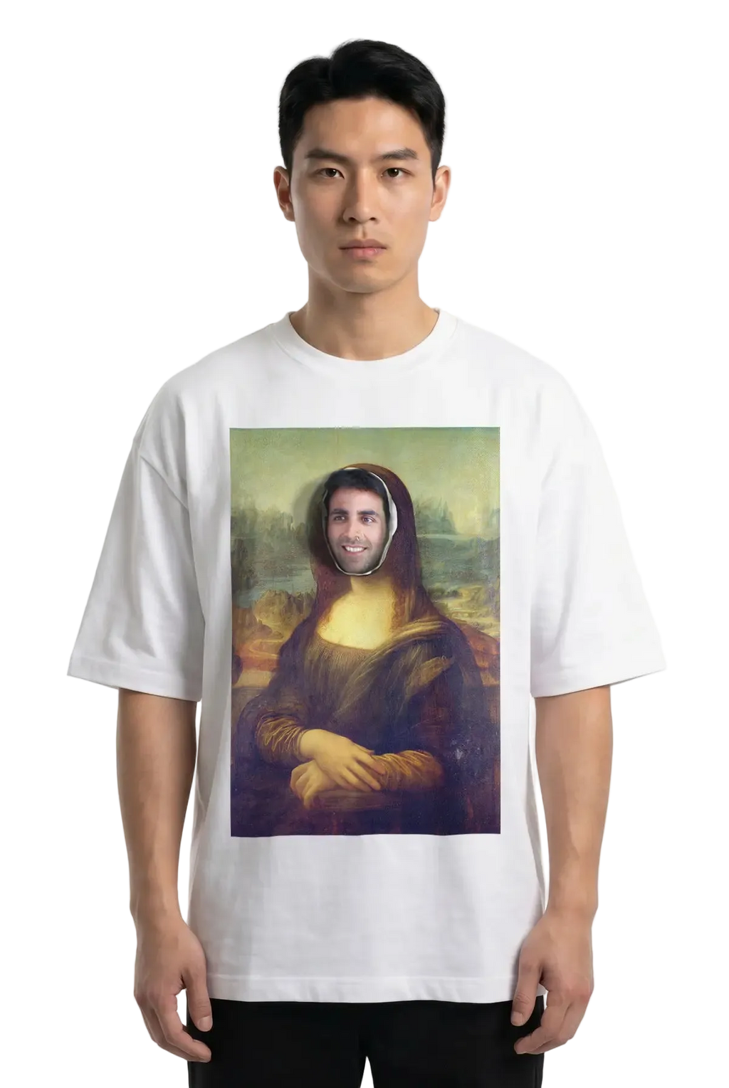 A man wearing a white t-shirt with a parody print of the Mona Lisa with a real person's face superimposed in the center, photographed against a plain white studio background.