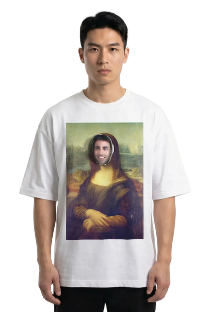 A man wearing a white t-shirt with a parody print of the Mona Lisa with a real person's face superimposed in the center, photographed against a plain white studio background.