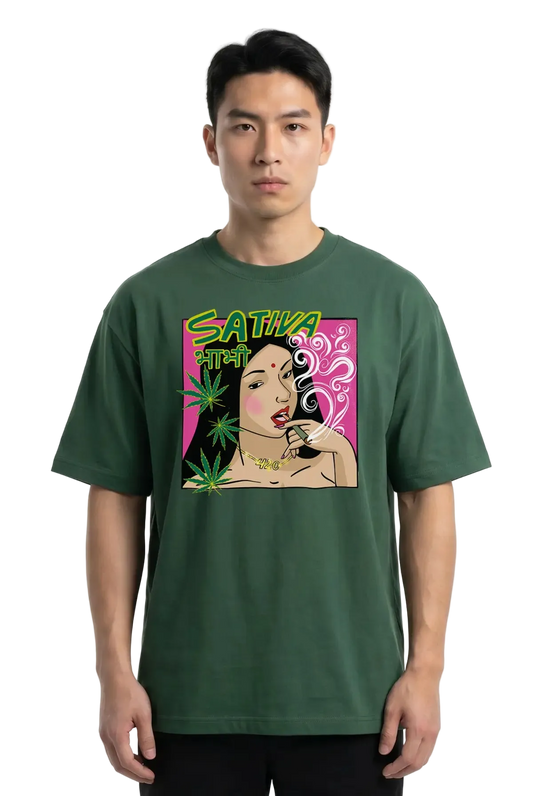 A man wearing a dark green t-shirt with a colorful graphic print on the front. The graphic features the text 'SATIVA' in neon green, a stylized illustration of a woman smoking, and green cannabis leaves on a pink background.