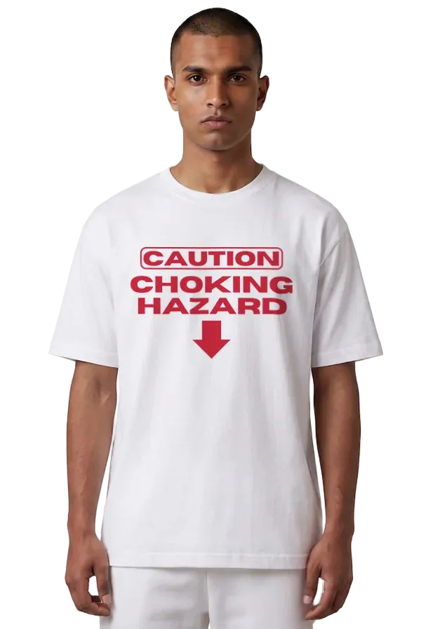 A man wearing a white short-sleeve t-shirt with a red graphic print that reads 'CAUTION CHOKING HAZARD' with a red arrow pointing down, set against a plain white background.
