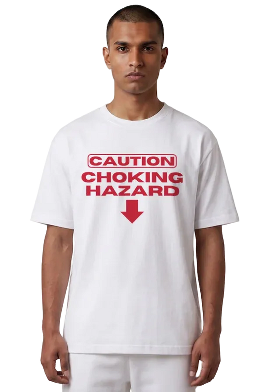 A man wearing a white short-sleeve t-shirt with a red graphic print that reads 'CAUTION CHOKING HAZARD' with a red arrow pointing down, set against a plain white background.