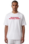 A man wearing a white short-sleeve t-shirt with the text 'DEAD INSIDE BUT STILL HORNAY' printed in red across the chest, set against a plain white background.