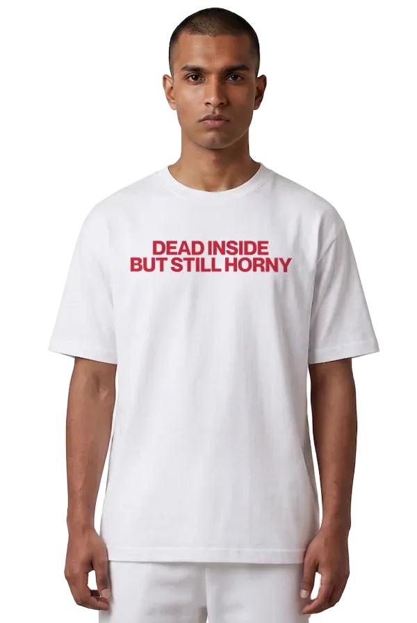 A man wearing a white short-sleeve t-shirt with the text 'DEAD INSIDE BUT STILL HORNAY' printed in red across the chest, set against a plain white background.
