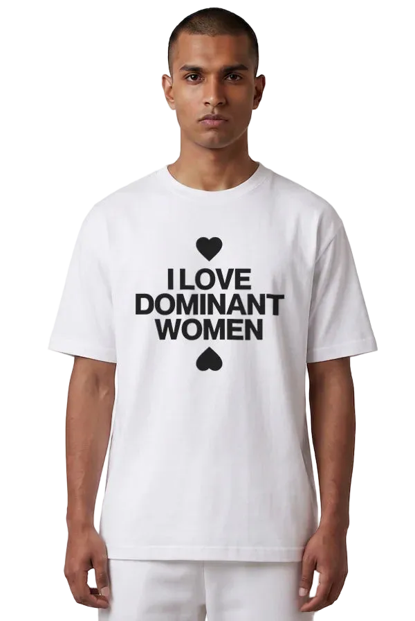 A man wearing a white short-sleeve t-shirt with a black graphic print that reads 'I LOVE DOMINANT WOMEN' with a heart and spade symbol, set against a plain white background.