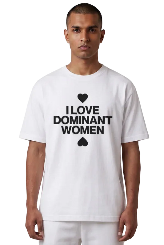 A man wearing a white short-sleeve t-shirt with a black graphic print that reads 'I LOVE DOMINANT WOMEN' with a heart and spade symbol, set against a plain white background.
