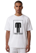 A man wearing a white crewneck t-shirt with a black graphic of a stick figure headless and the text 'I NEED HEAD!' printed on the front, set against a plain white background.
