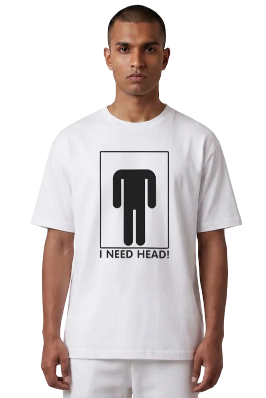 A man wearing a white crewneck t-shirt with a black graphic of a stick figure headless and the text 'I NEED HEAD!' printed on the front, set against a plain white background.