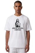 A man wearing a white crewneck t-shirt with a black graphic of Jesus and the text 'JESUS SAVES, I SPEND' printed on the front, set against a plain white background.