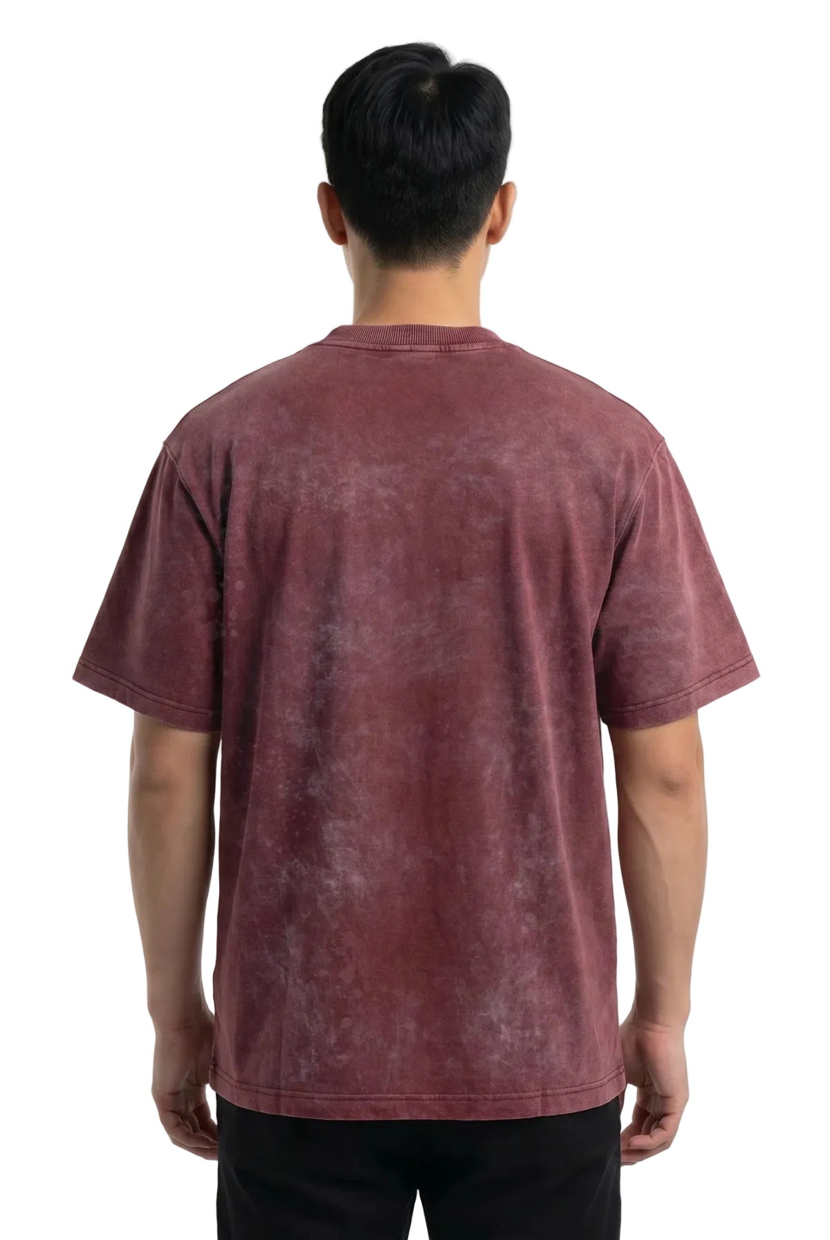 A man viewed from behind wearing a short-sleeve crewneck t-shirt with a washed, mineral-look finish in a dusty rose or mauve color, paired with black pants against a plain white background.