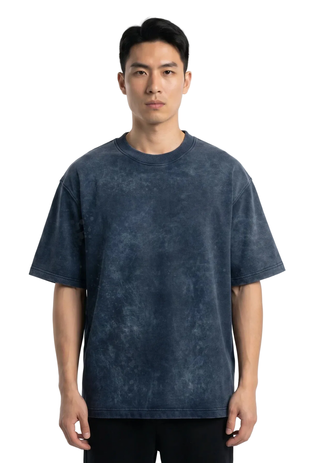 A man wearing a dark blue acid-wash t-shirt and black pants, standing against a plain white studio background.