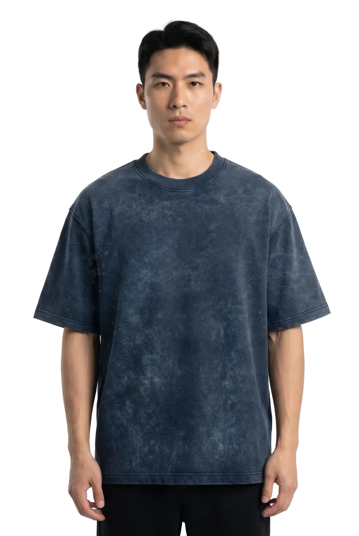 A man wearing a dark blue acid-wash t-shirt and black pants, standing against a plain white studio background.