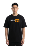 A man wearing a black short-sleeve t-shirt with a graphic on the chest that reads 'Nice guy' in white and orange, set against a plain white studio background.