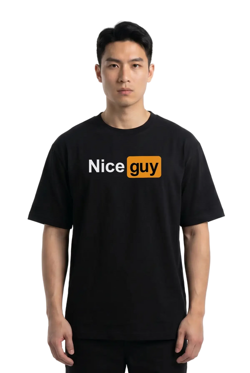 A man wearing a black short-sleeve t-shirt with a graphic on the chest that reads 'Nice guy' in white and orange, set against a plain white studio background.