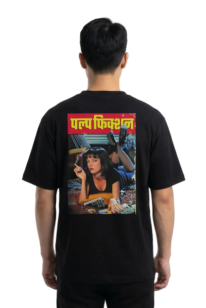 A man viewed from the back wearing a black t-shirt with a large graphic print on the back. The print features the Hindi text 'Pulp Fiction' in yellow on a red banner above a colorful illustration of a woman.