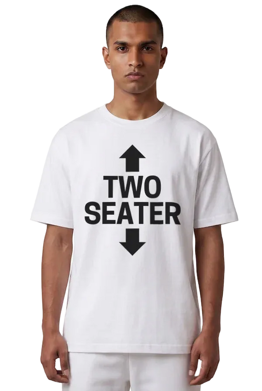 A man wearing a white short-sleeve t-shirt with a bold black graphic print on the front that reads 'TWO SEATER' with arrows pointing up and down, set against a plain white background.